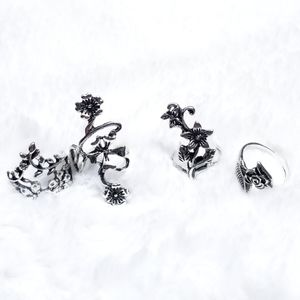 Four floral silver tone boho rings